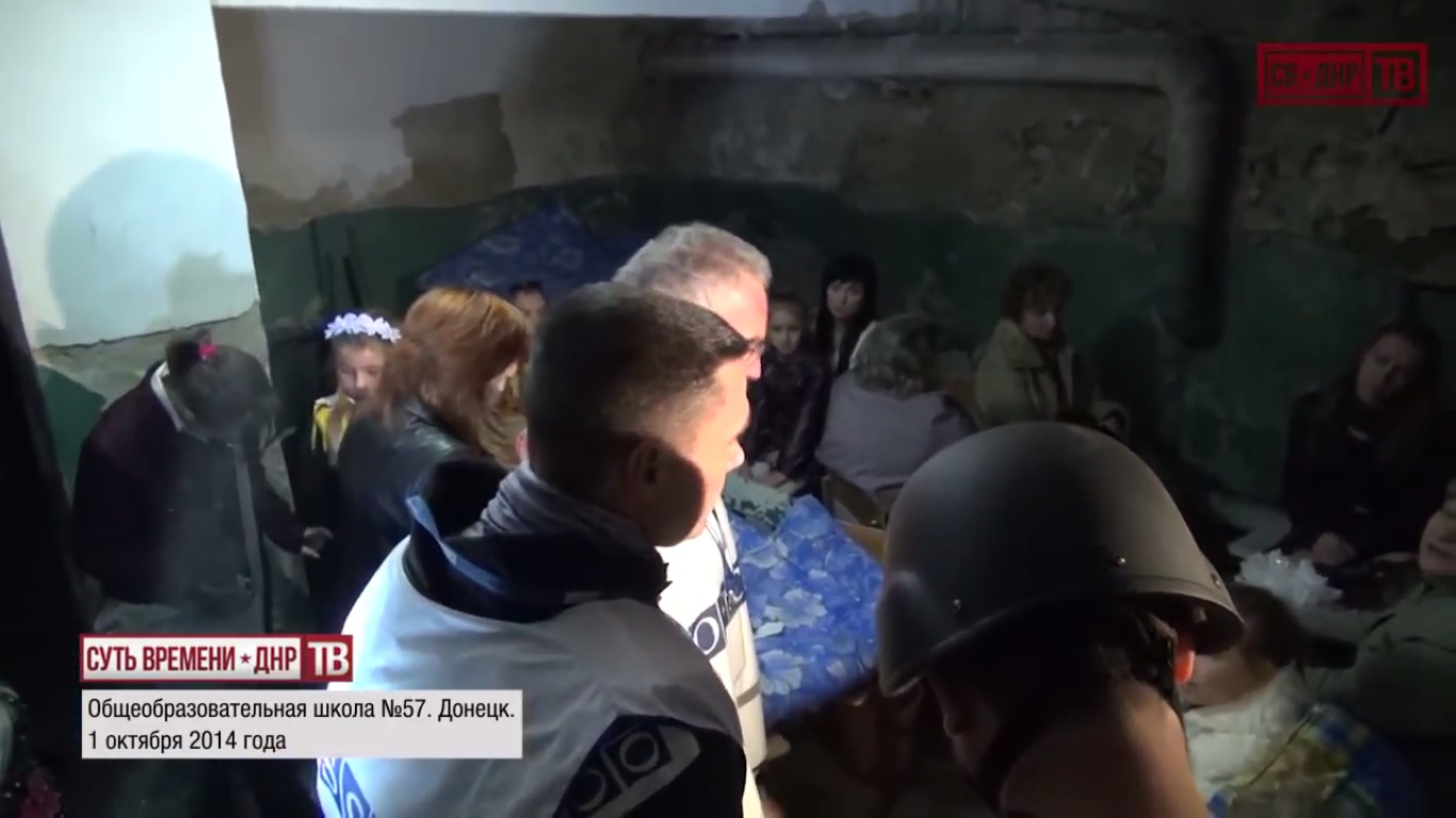 Kiev's punitive forces delivering on Poroshenko's promise to have children of Donbass hide in basements instead of going to school. Children hide in basement as OSCE inspects shelled school №57. October 1, 2014.  Still from EoT-DPR TV Issue 213
