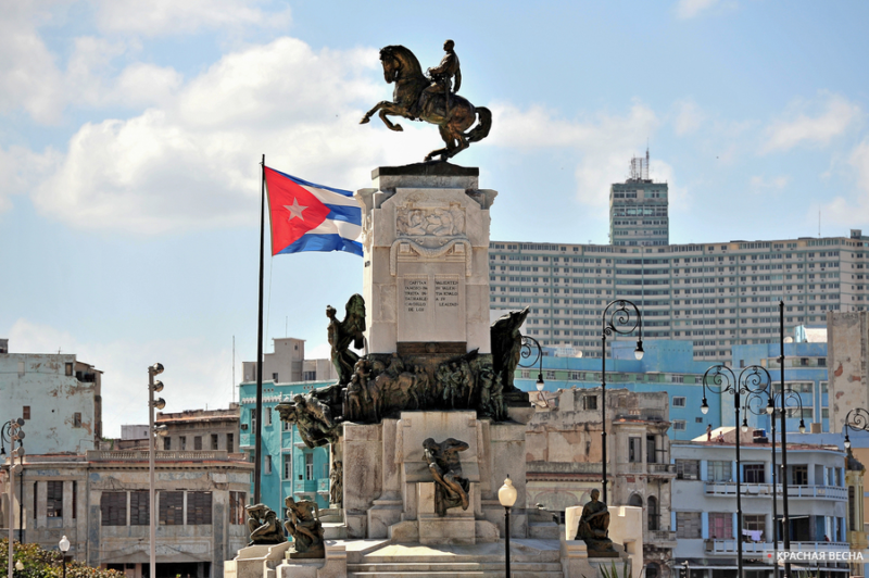 Flag of Cuba and Antonio Maceo Monument in Havana