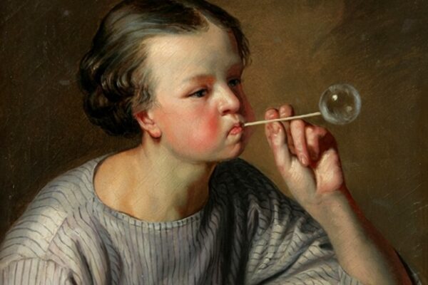 A boy blowing a soap bubble